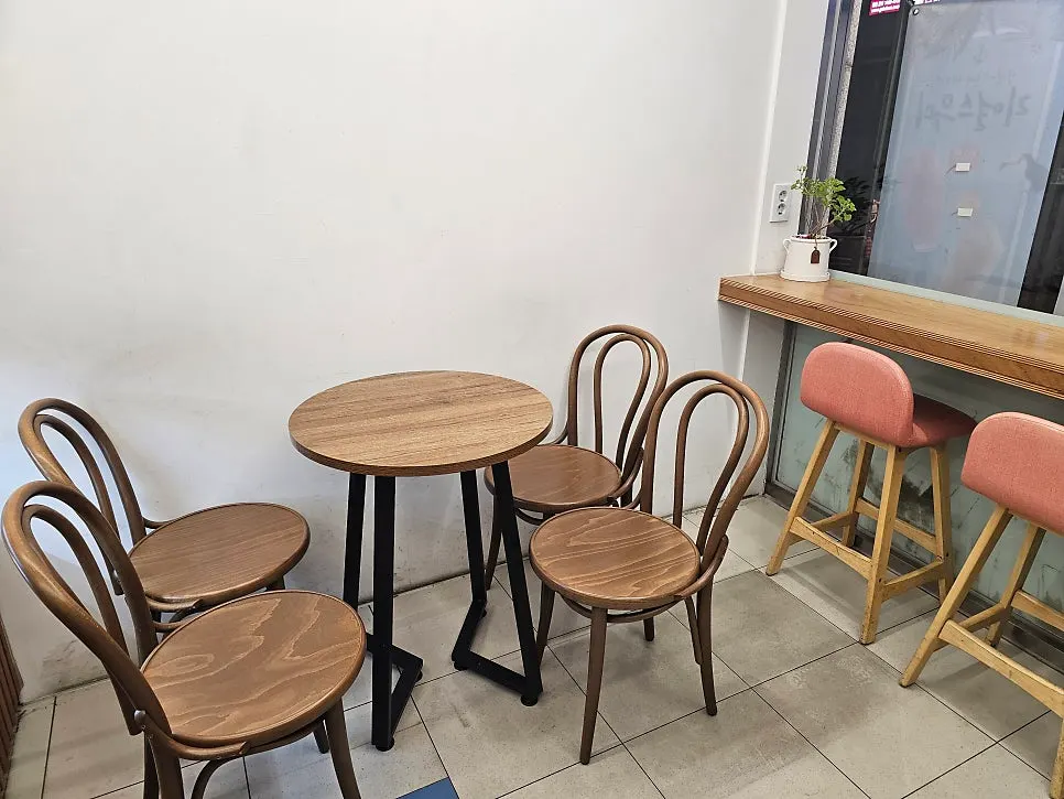 Store interior with round tables and window seats