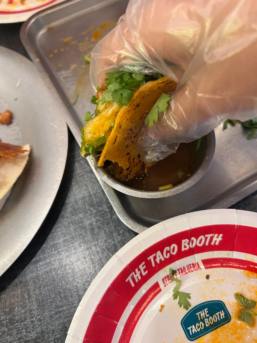 Half-eaten plate of tacos and quesadilla