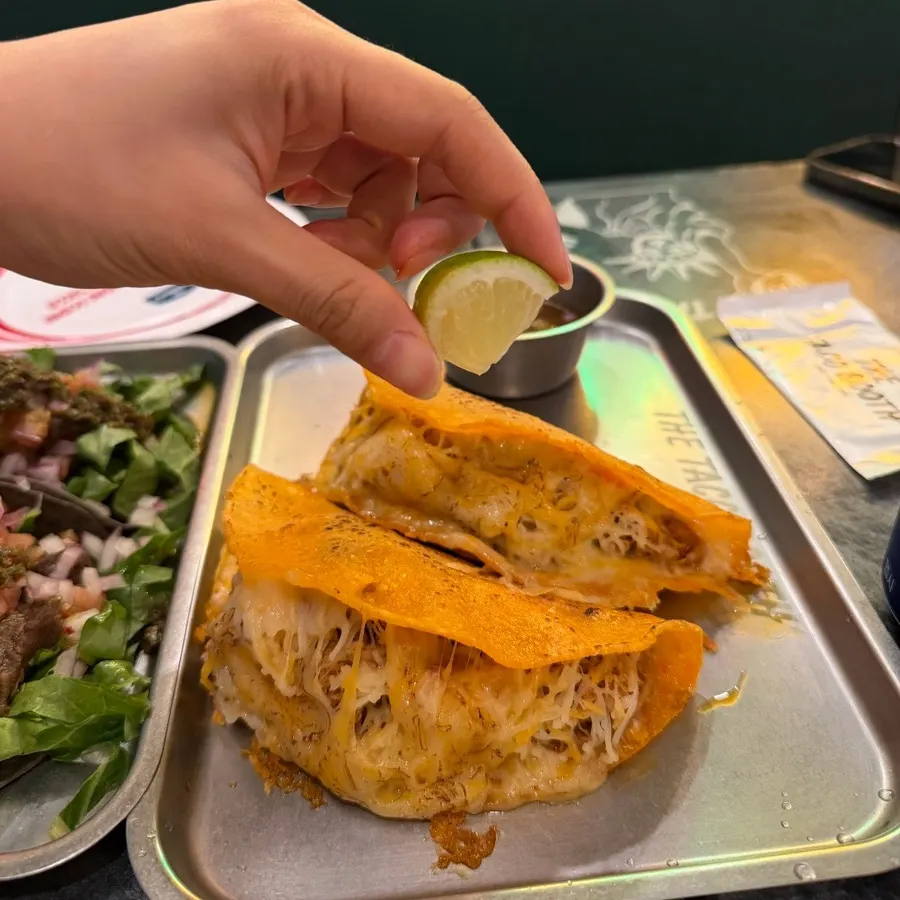 Close-up of birria taco with lemon on the side