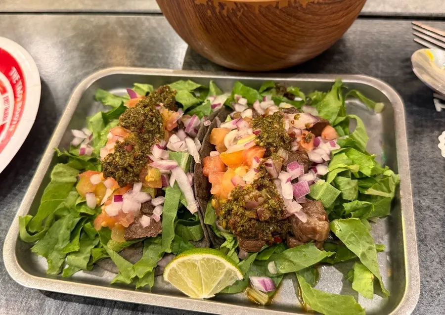 Carne asada taco topped with steak