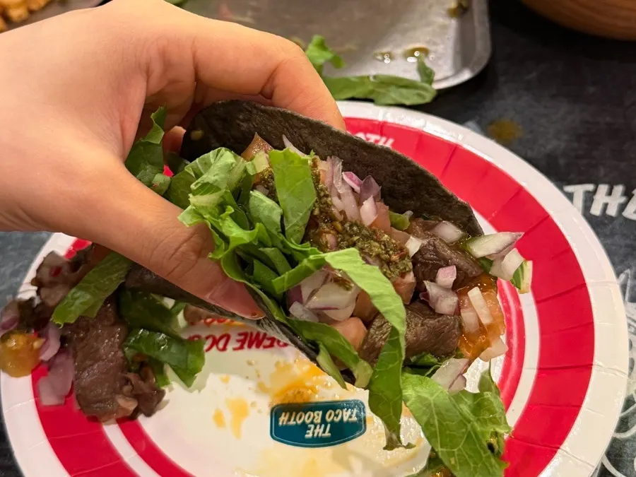 Carne asada taco topped with onions and other toppings