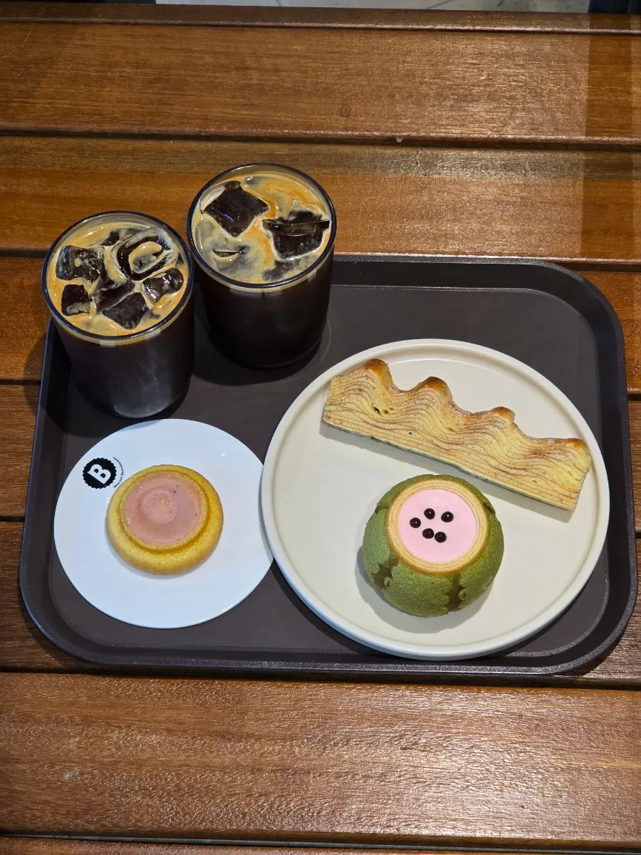 Table setting with a cold iced drink and baumkuchen