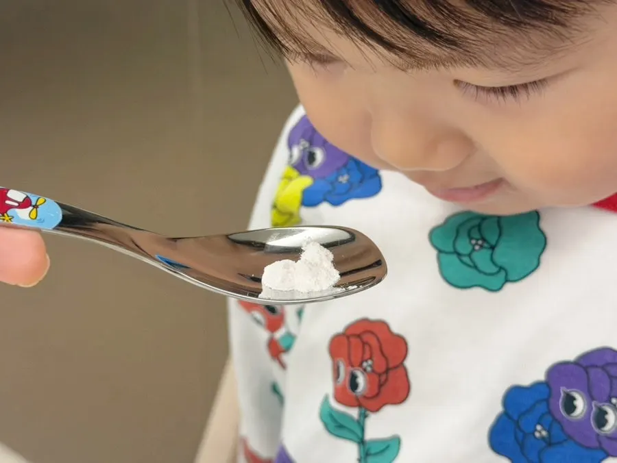 A child tasting Tunteun Kids Cal-Mag-D for the first time