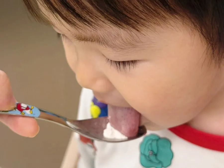 A child’s reaction while tasting strawberry-flavored Cal-Mag-D