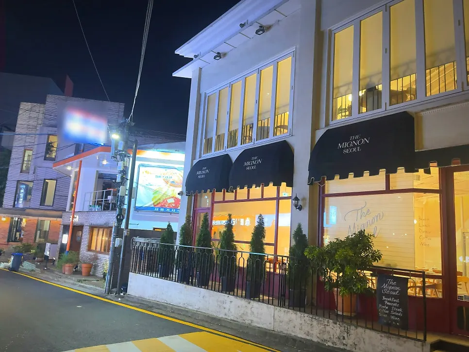 The Mignon Seoul's European-style facade decorated with flower pots and flowers