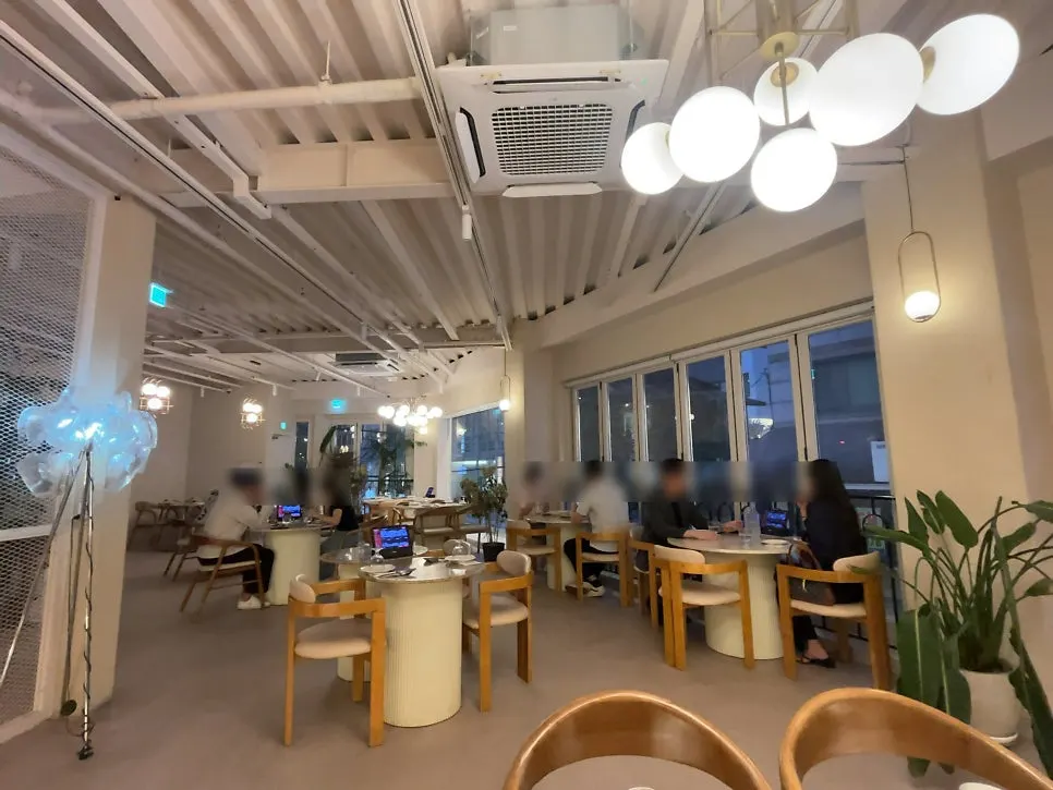 Second floor of The Mignon Seoul with engagement party tables and couple seats