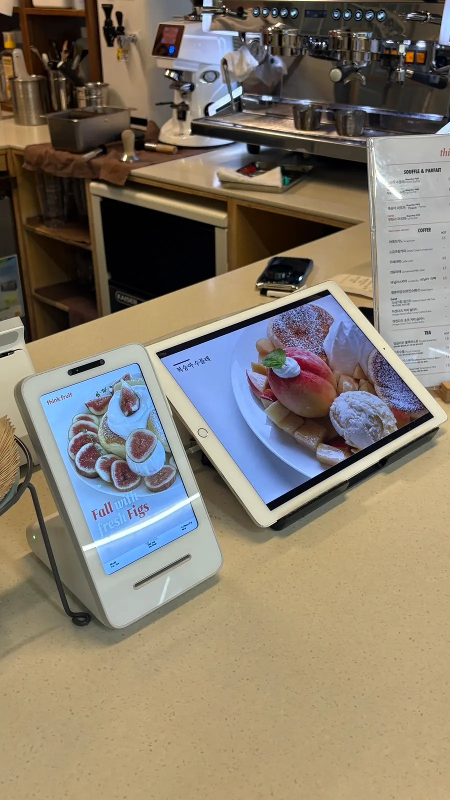 Photos of peach soufflé and fig soufflé beside the menu board