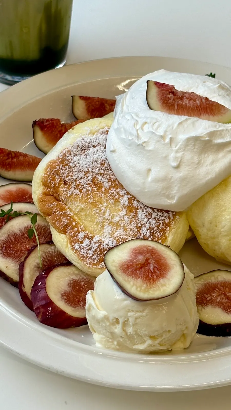 Three soufflé pieces topped with whipped cream and figs