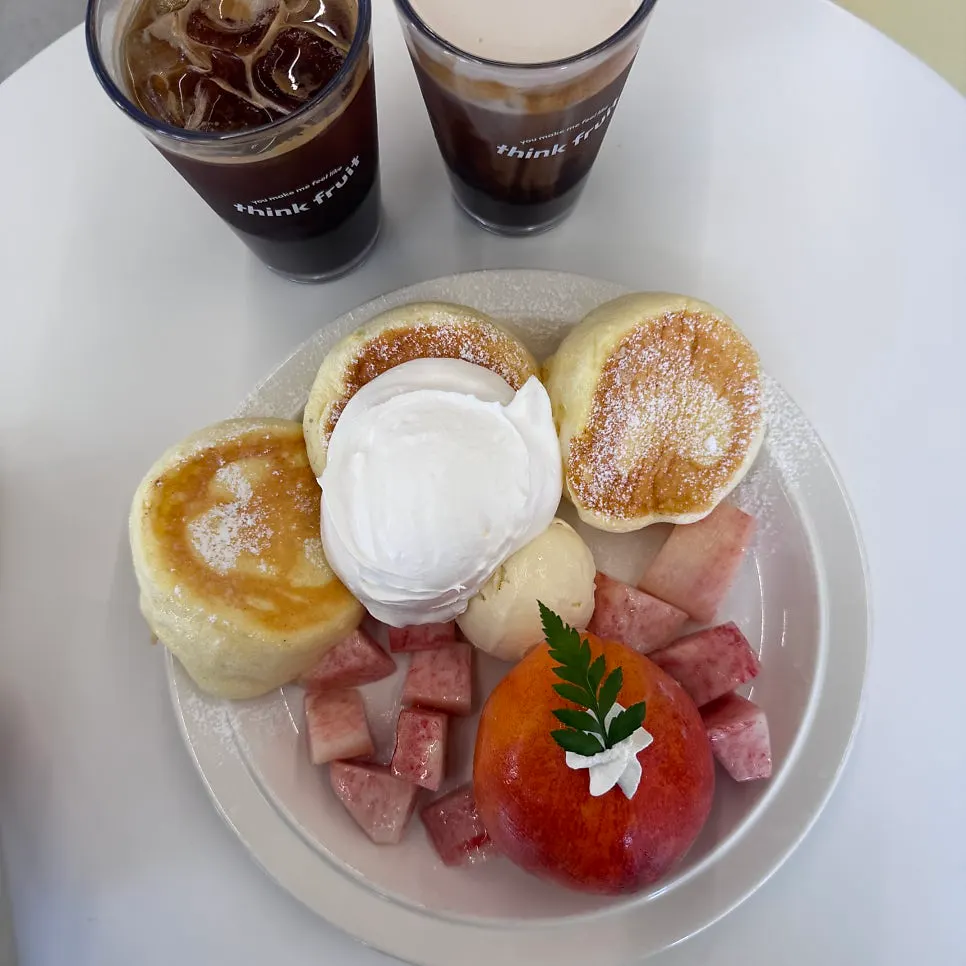 A plate of peach soufflé with whipped cream and ice cream
