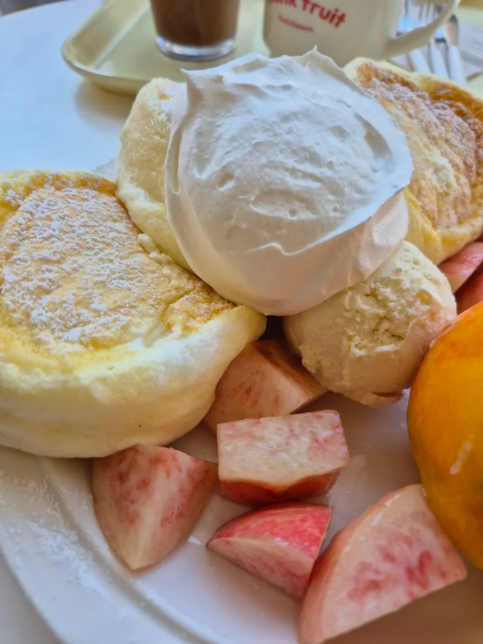 A plate of soufflé topped with peach