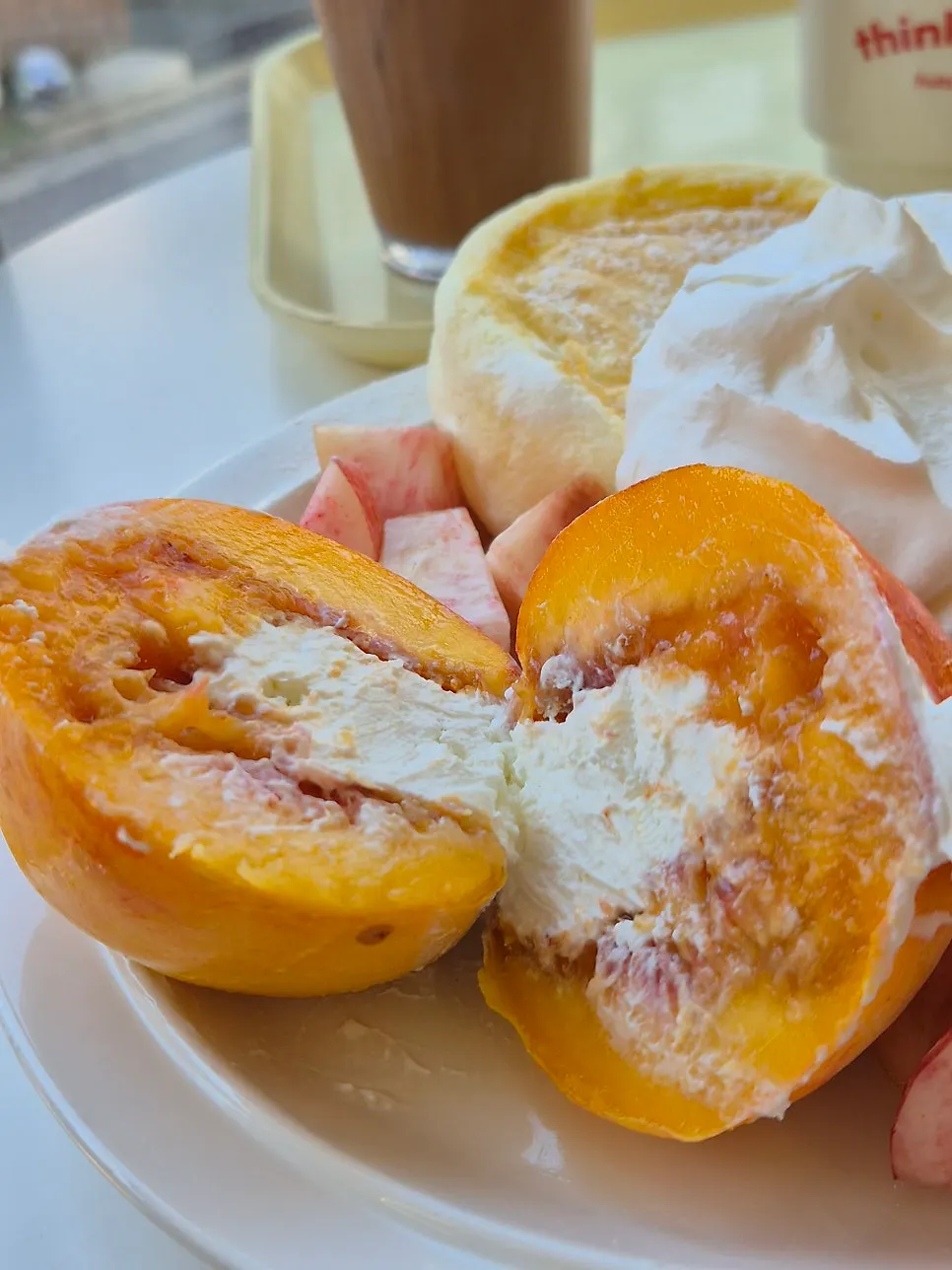 Soufflé topped with peach and cream together