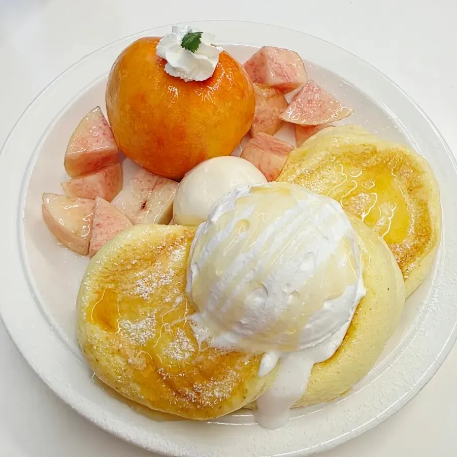 Peach soufflé topped with a whole peach