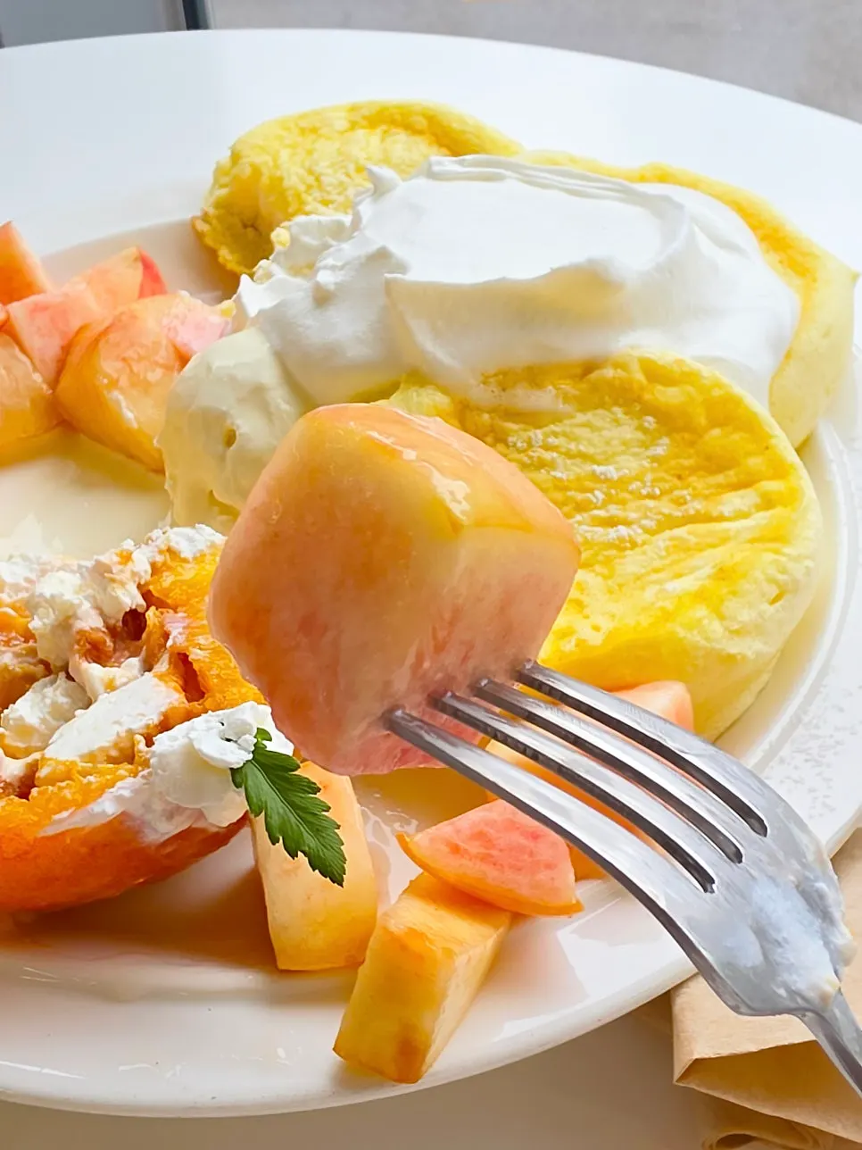 A bite of soufflé with peach and yogurt