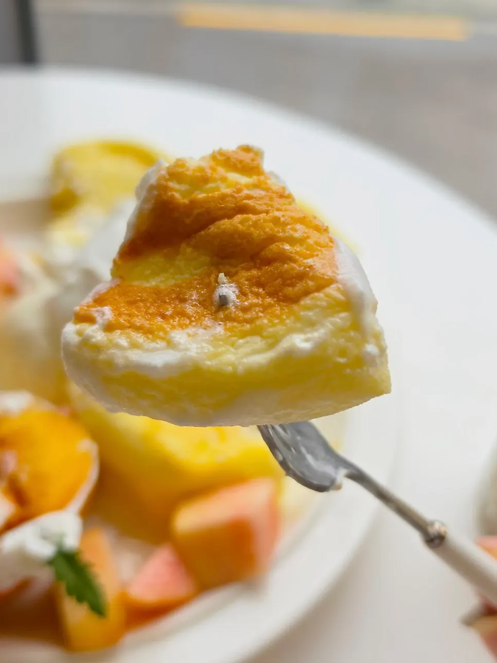 A piece of soufflé dipped in whipped cream