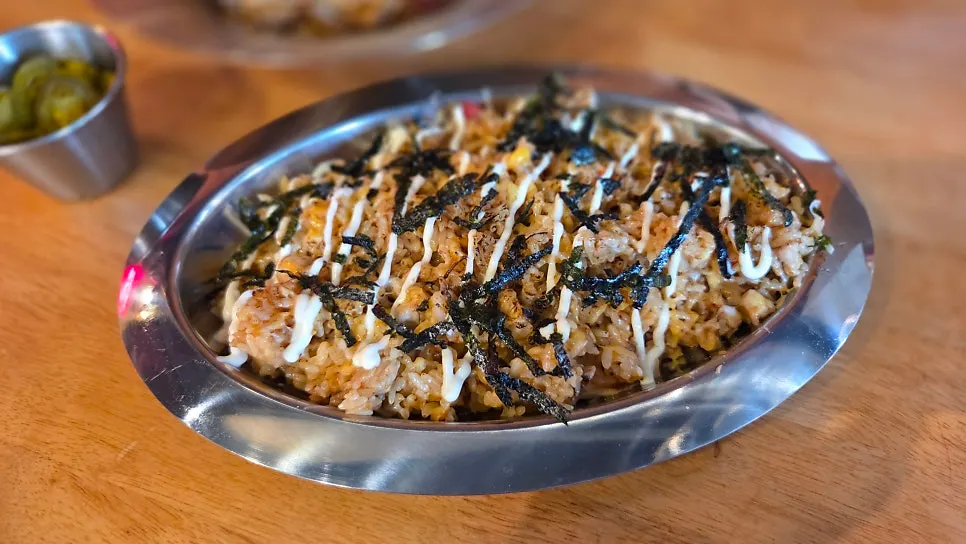 Smoky pork rice pilaf topped with seaweed flakes and mayo sauce