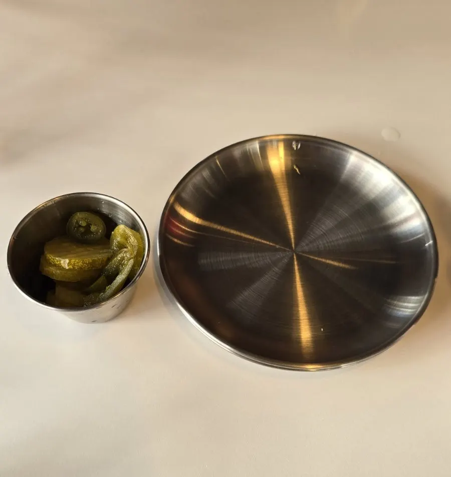 Pickles and jalapeños on a steel plate