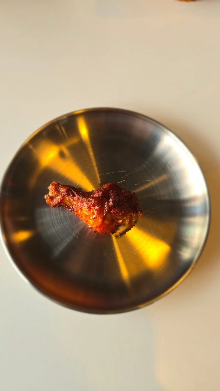 Four pieces of wings and drumsticks on wax paper
