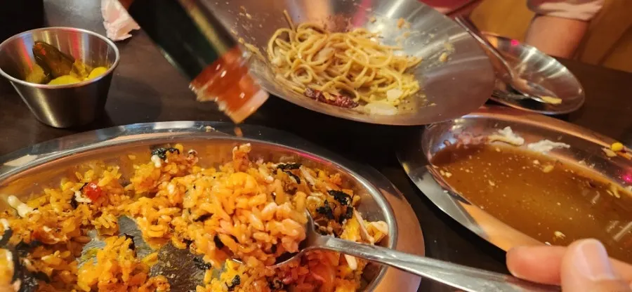 Hot sauce from the table drizzled over the kimchi bacon pilaf