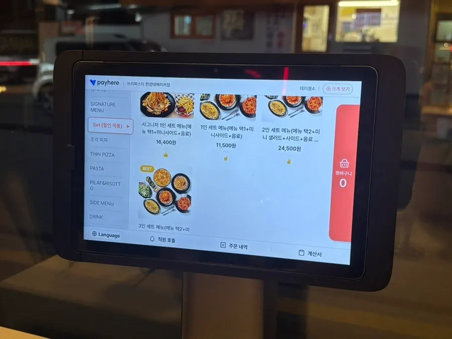 Menu board listing pasta dishes