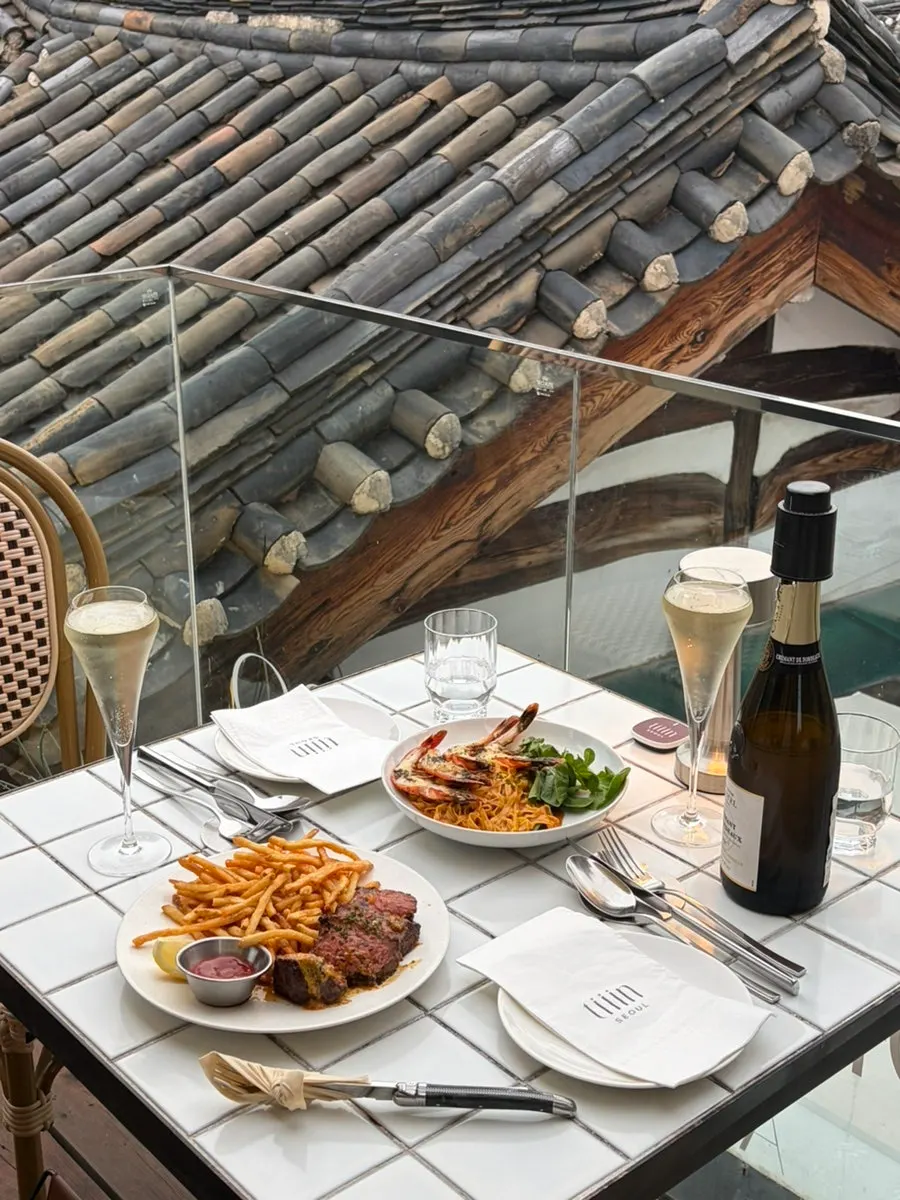 Table setting with Steak Frites and linguine ordered at Teen Seoul