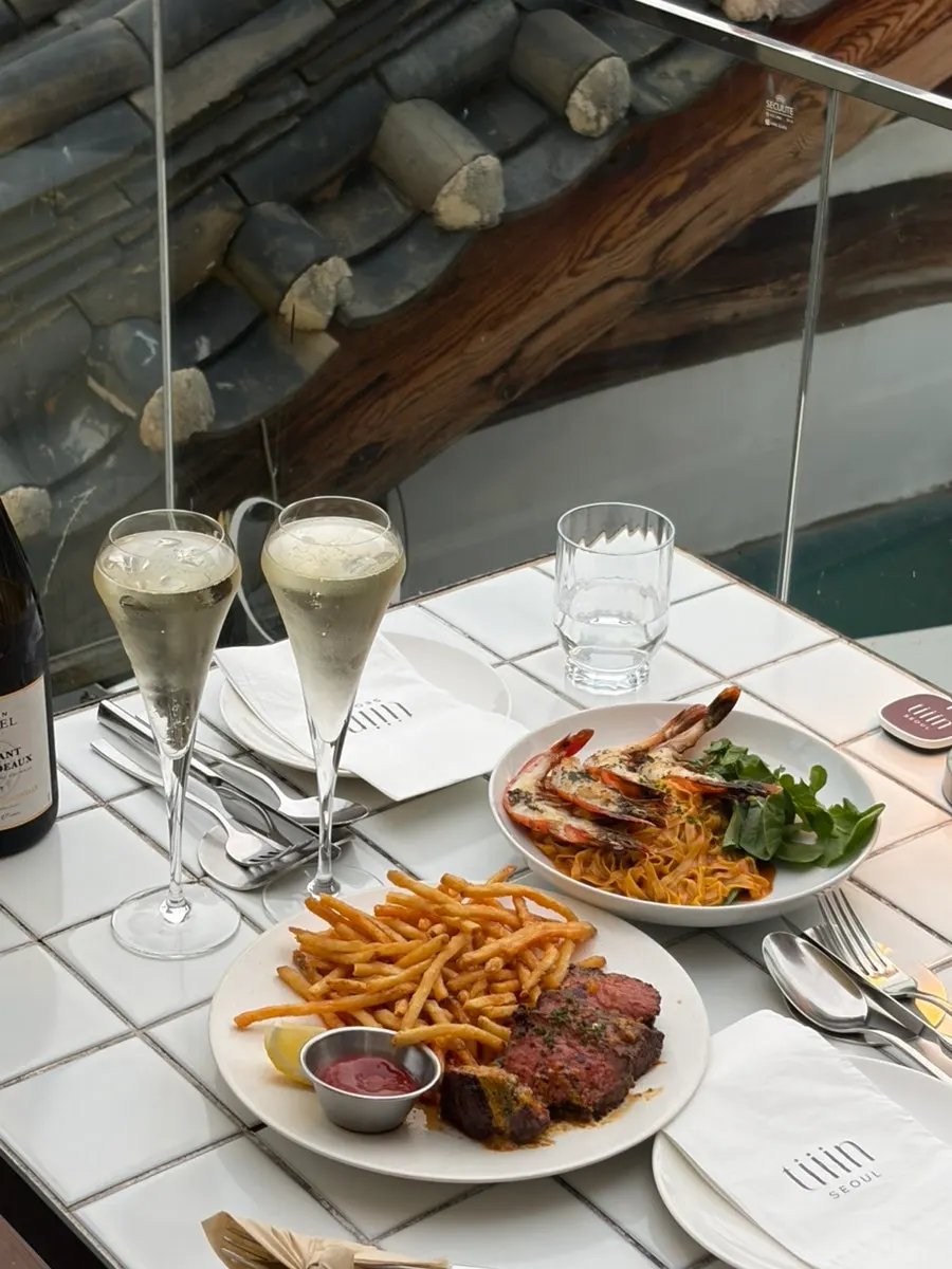 Table with both pasta and steak served together