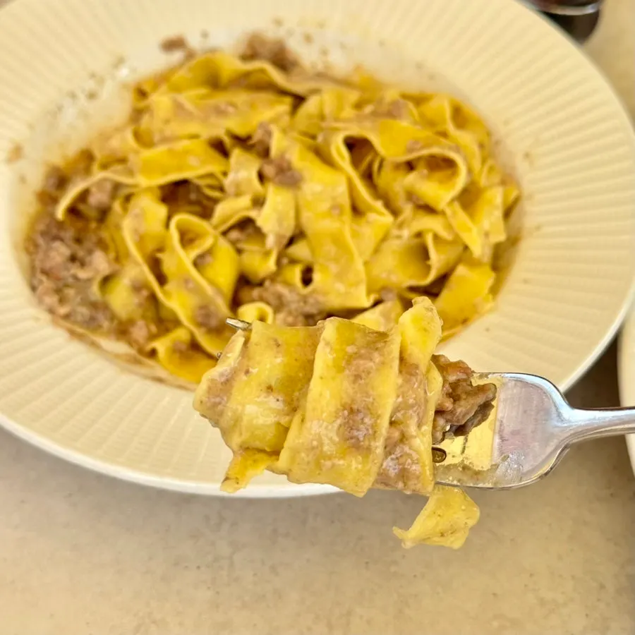 White ragu pasta topped with pecorino cheese