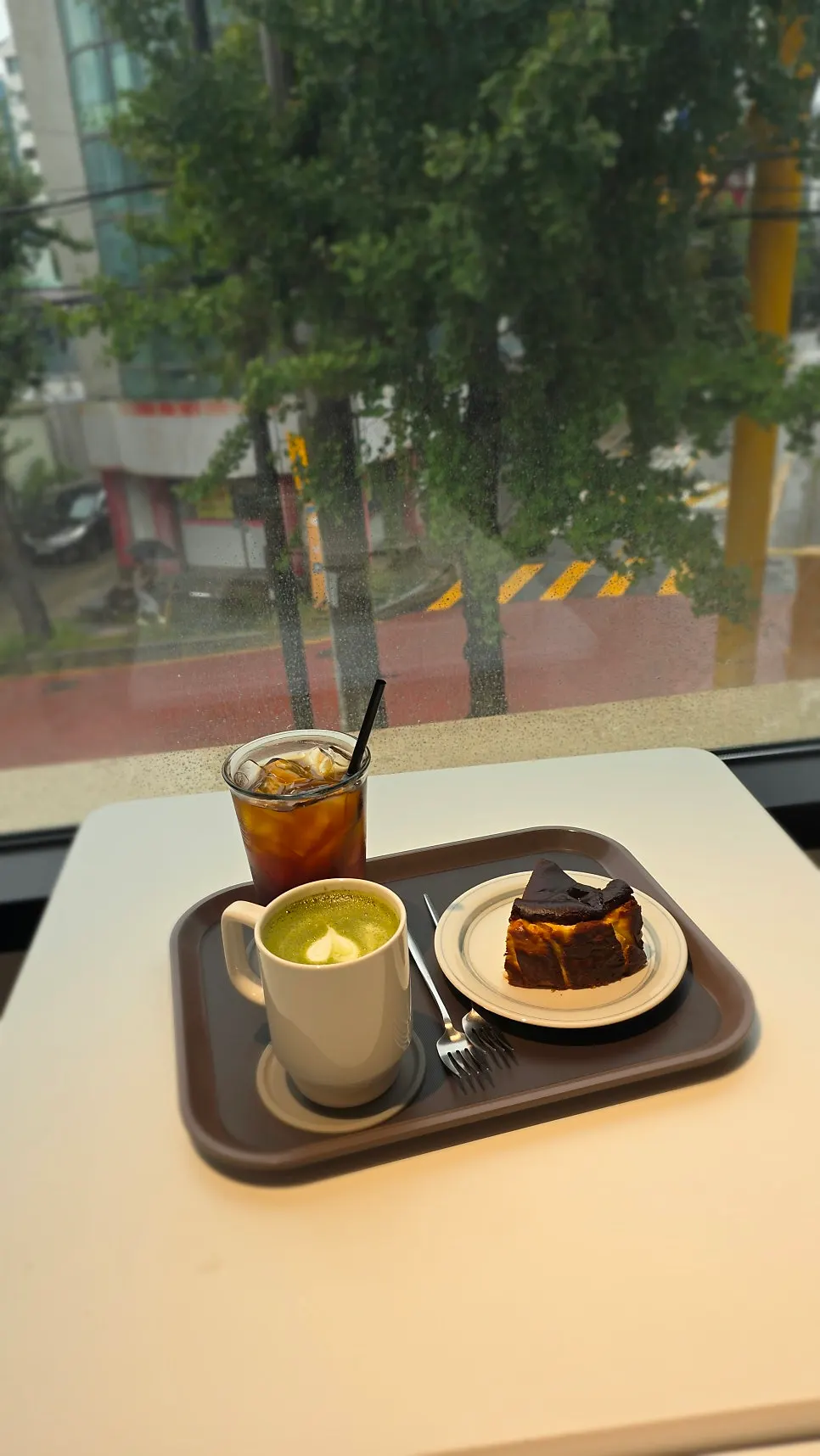 Drinks and dessert set at a window seat