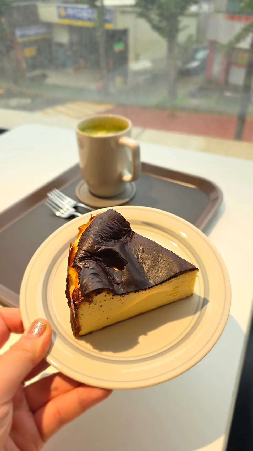 Basque cheesecake served together with a drink on the table