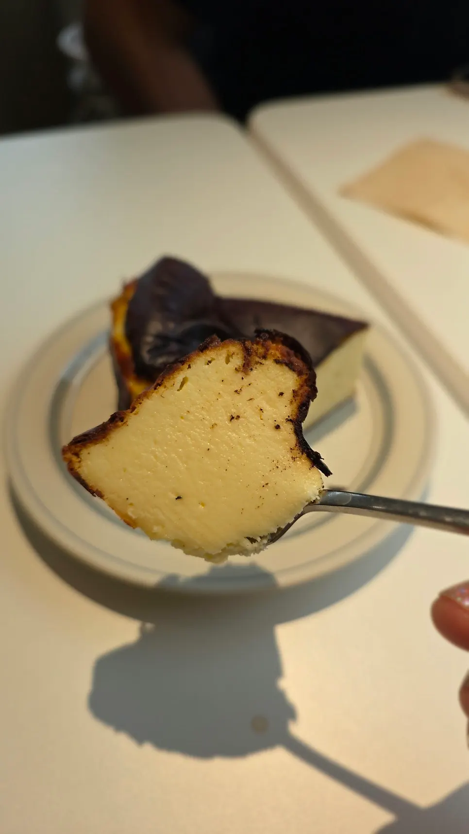 Cross-section of the dense Basque cheesecake cut with a fork