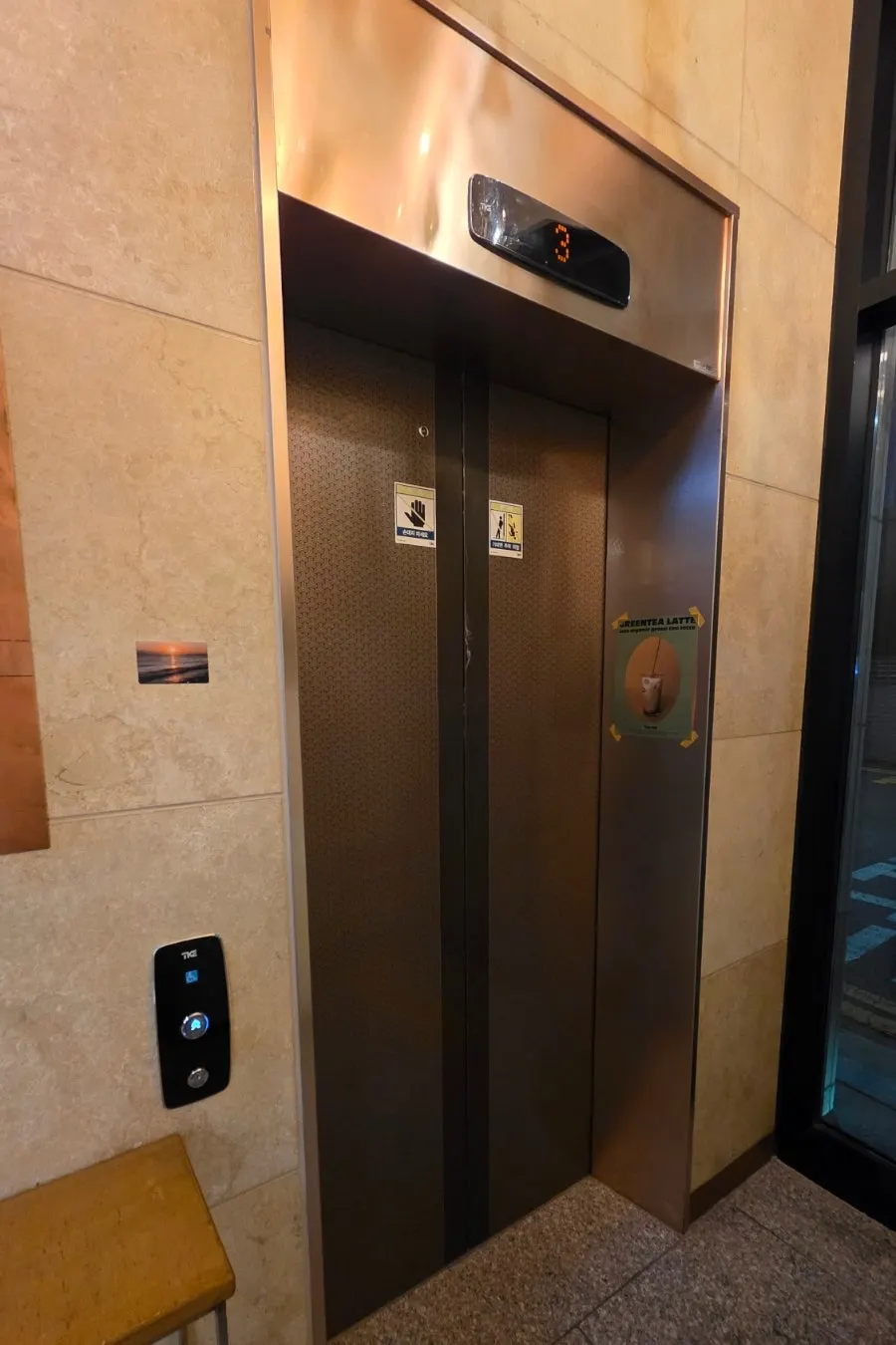 Inside Tiny Dot's elevator, fitted with a tray shelf