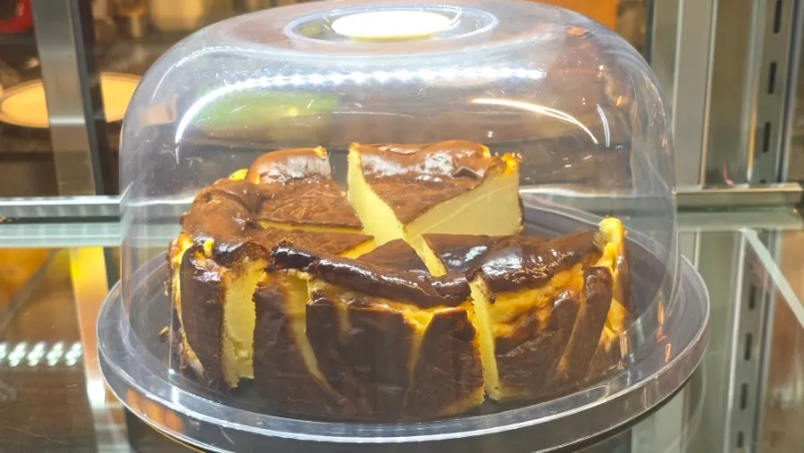 Handmade Basque cheesecake displayed in the showcase