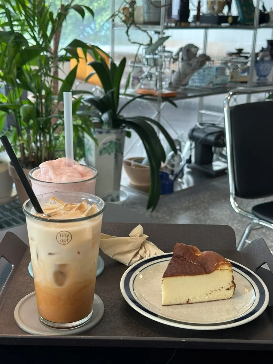 Drinks and cheesecake set on a table at Tiny Dot