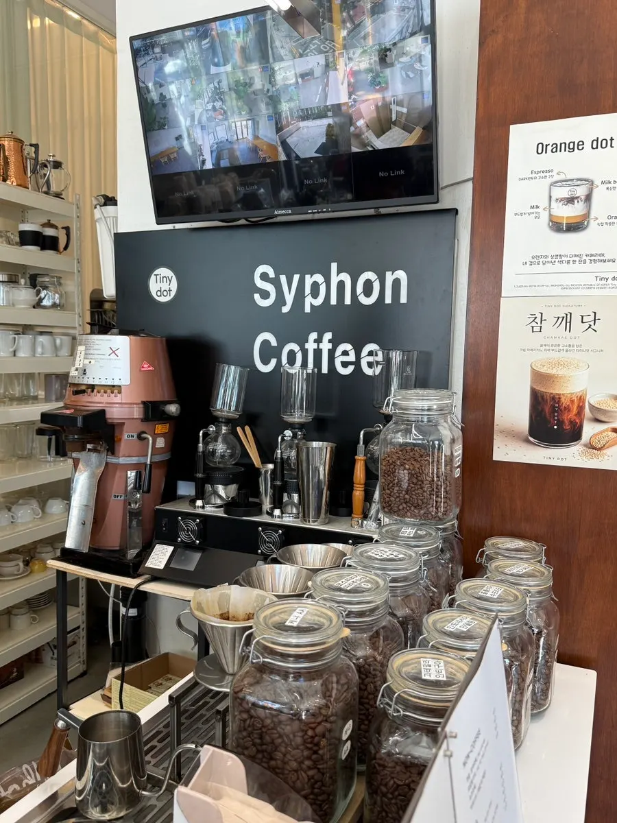 First-floor space with a roastery machine behind the glass window