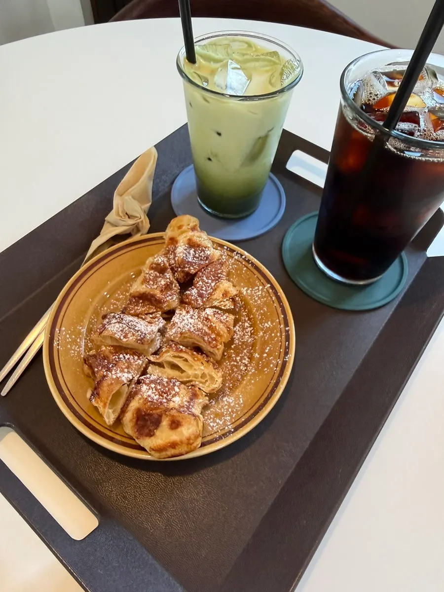 Table with croffle, stone-mill matcha latte, and cold brew americano