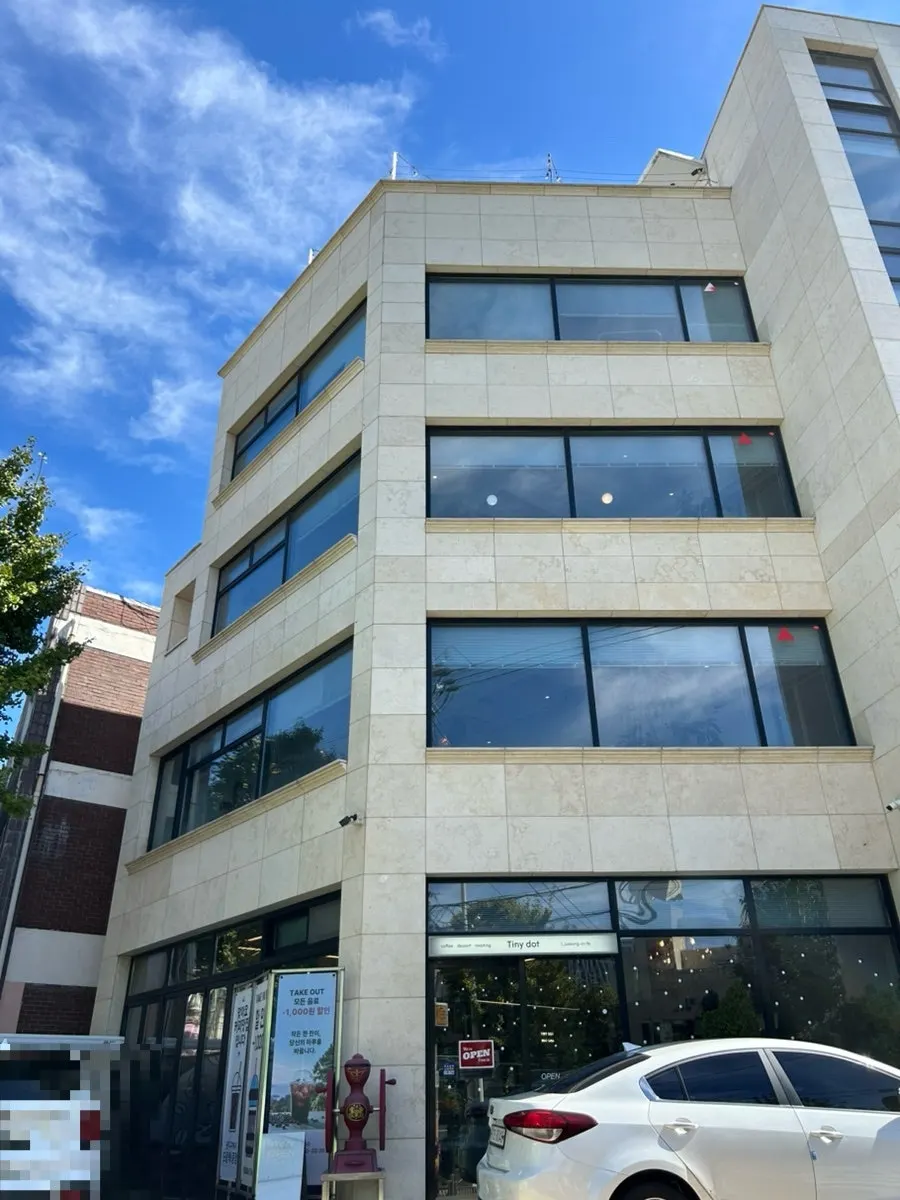 Exterior of the Tiny Dot building and its parking spaces