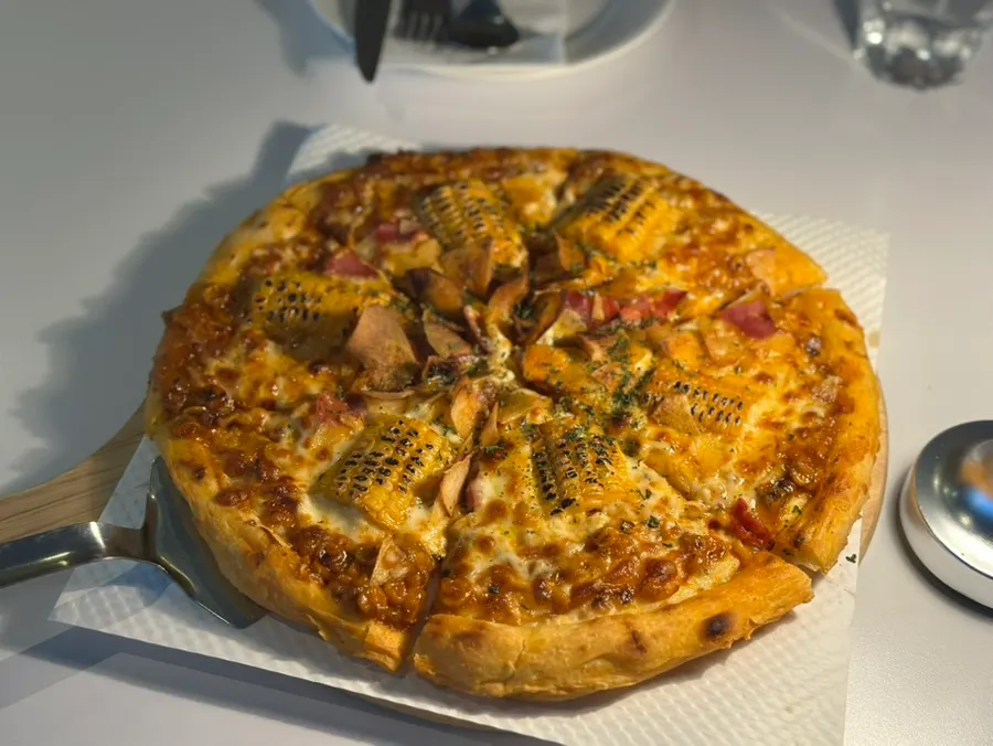 Corn pizza just placed on the table