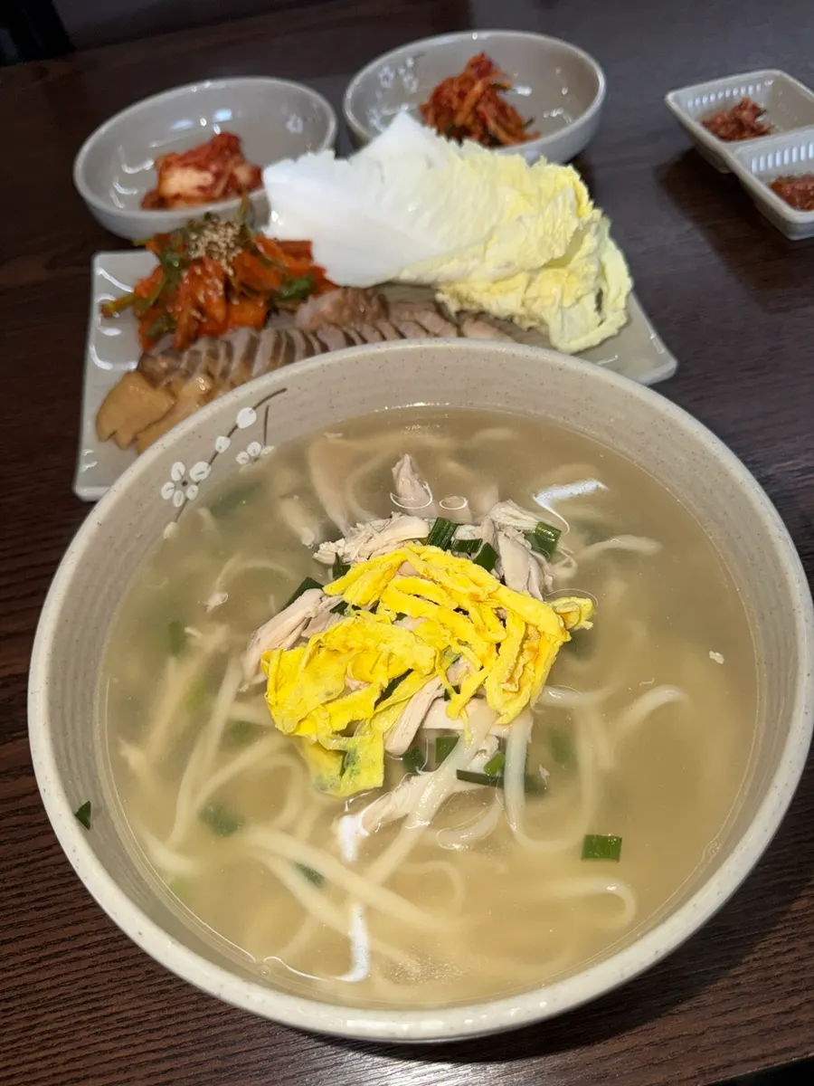 Chicken kalguksu and bossam side spread at Todamok