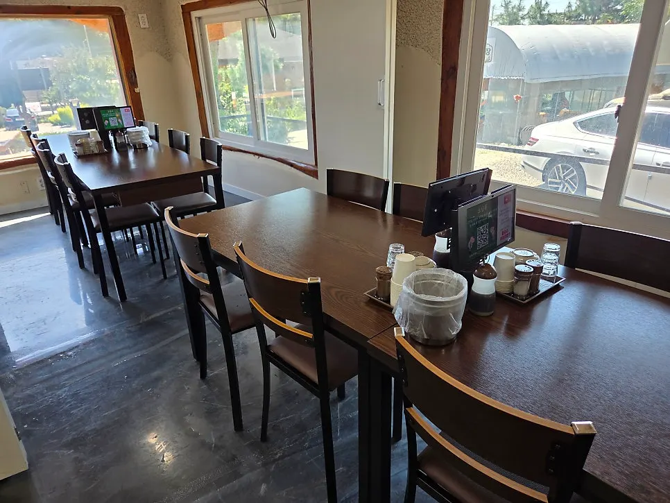 Interior of Todamok's dining hall with a green view outside the window