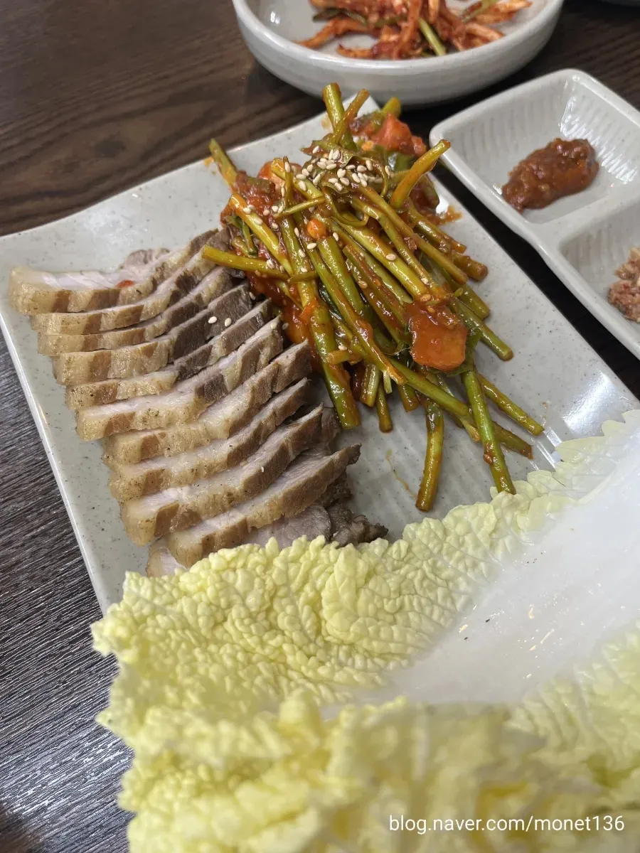 Spread of side dishes at Todamok including kimchi and dried radish