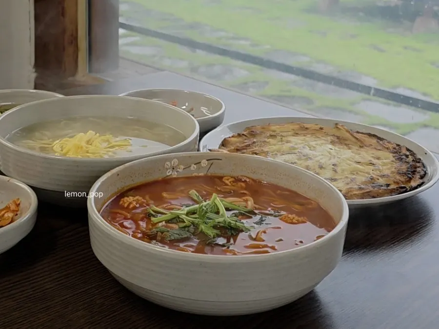 Full table spread of the two-person kalguksu and potato pancake lunch set
