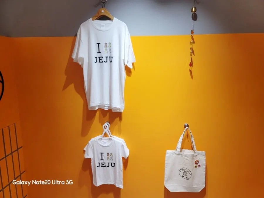T-shirts and eco bags hanging on the store wall
