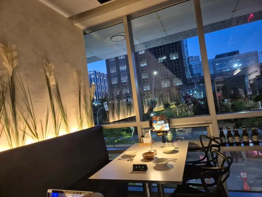 Window-side seating at sunset