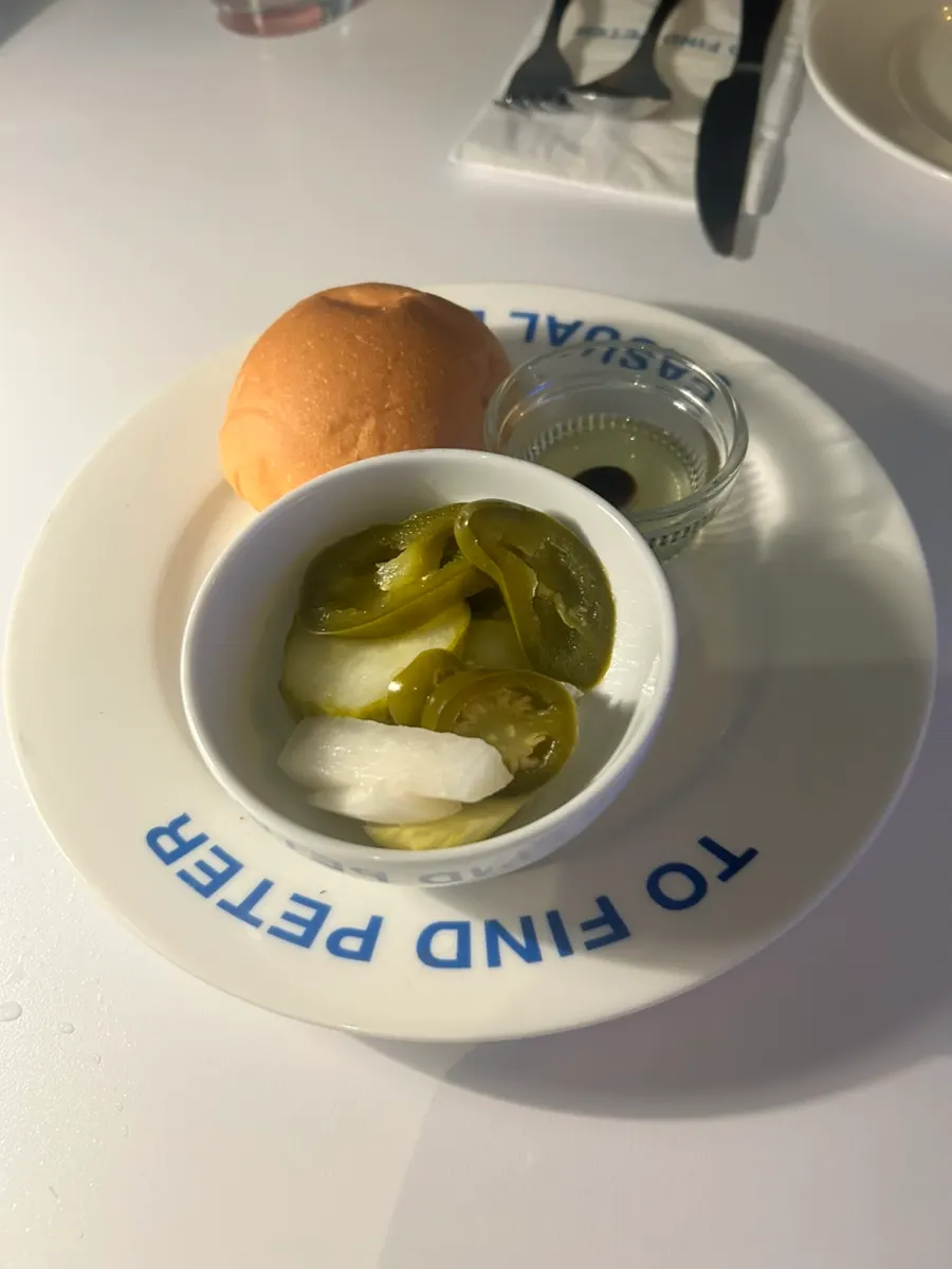 Side dish plate with pickles, jalapeños, and radish