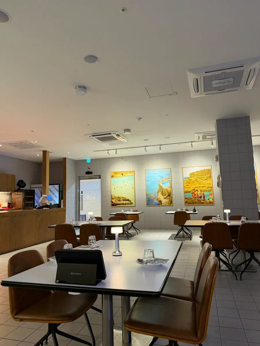 Dining hall at Two Find Peter Eungye Branch with large framed photos