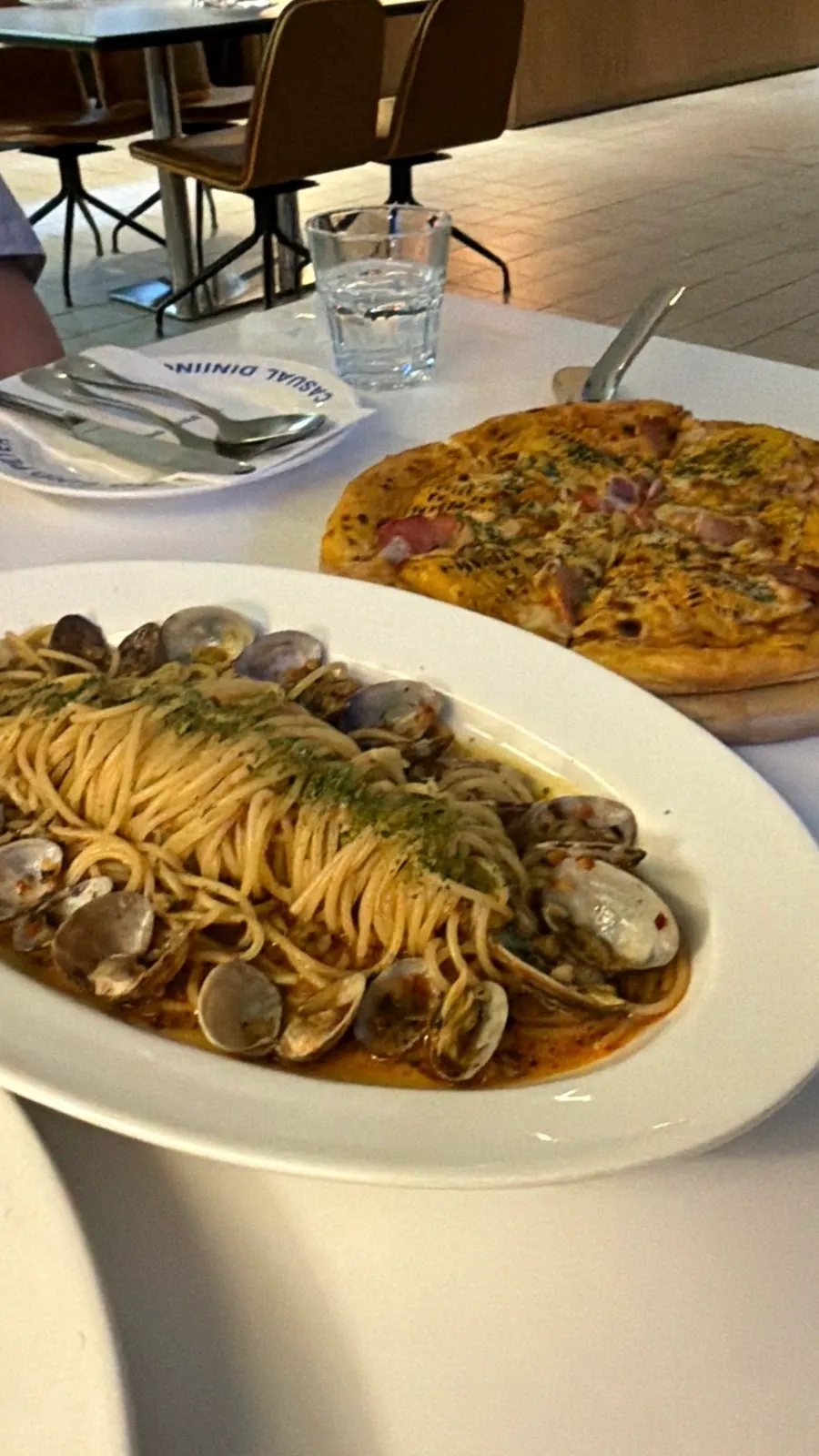 Corn pizza served alongside the pastas