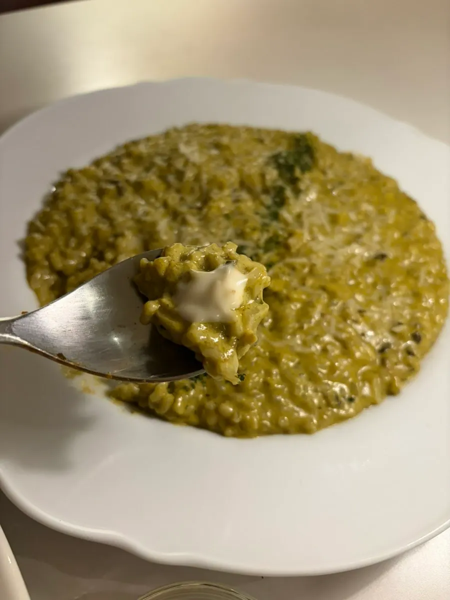 A bite of risotto with wasabi mayo sauce