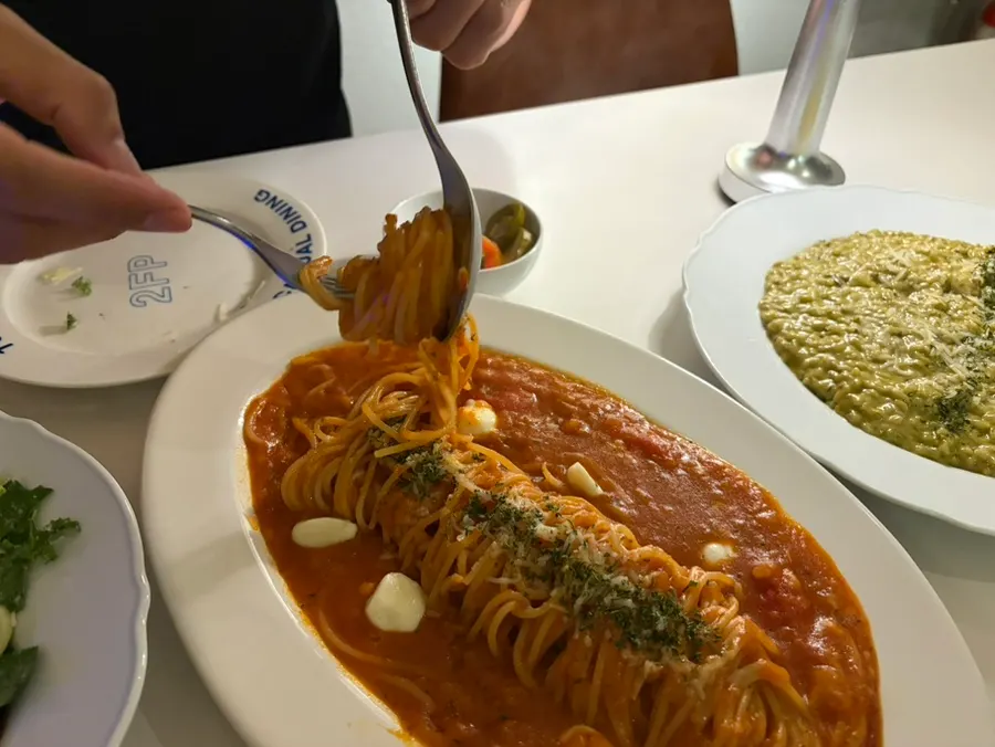 Tomato pasta topped with bocconcini cheese