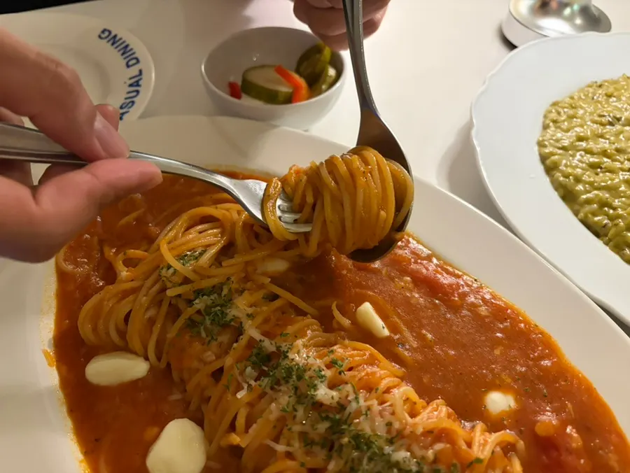 Tomato pasta noodles twirled around a fork