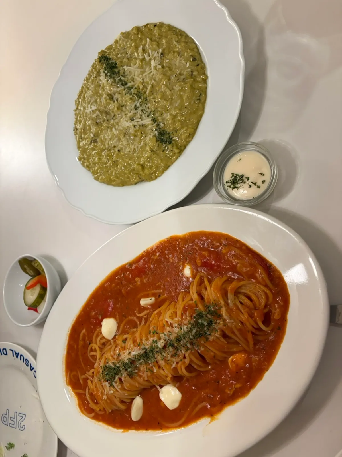 Table set with both risotto and tomato pasta