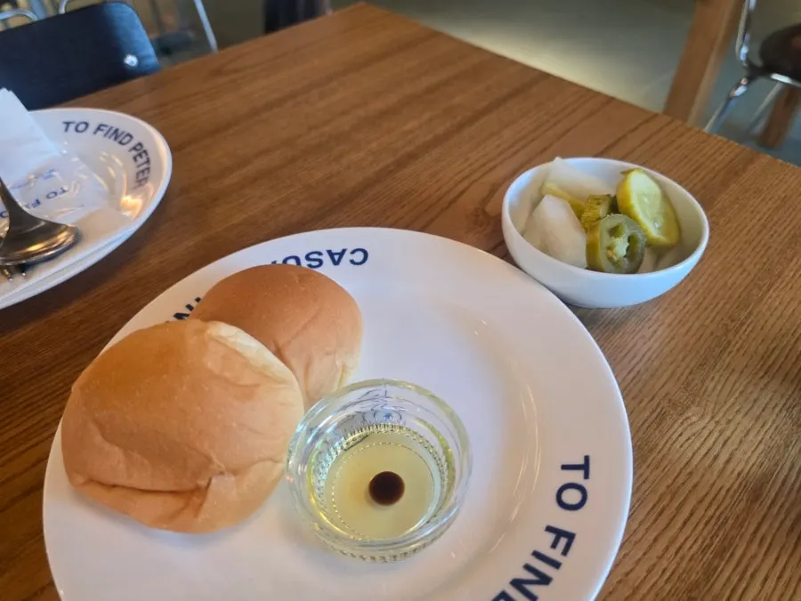 Table set with pre-meal bread and pickles